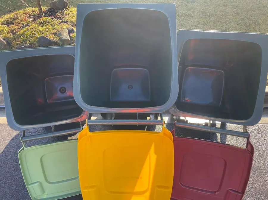The same three wheelie bins gleaming after cleaning