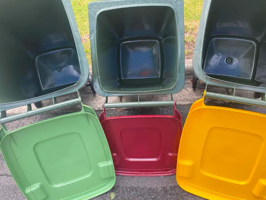 Three wheelie bins spotless inside, lids gleaming, after a Bin Doctor clean