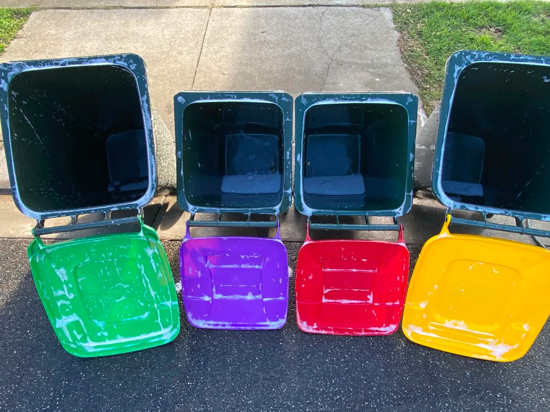 The same bins mid-clean, covered in hot soapy water